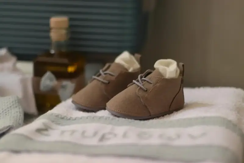 Tiny baby shoes on a blanket